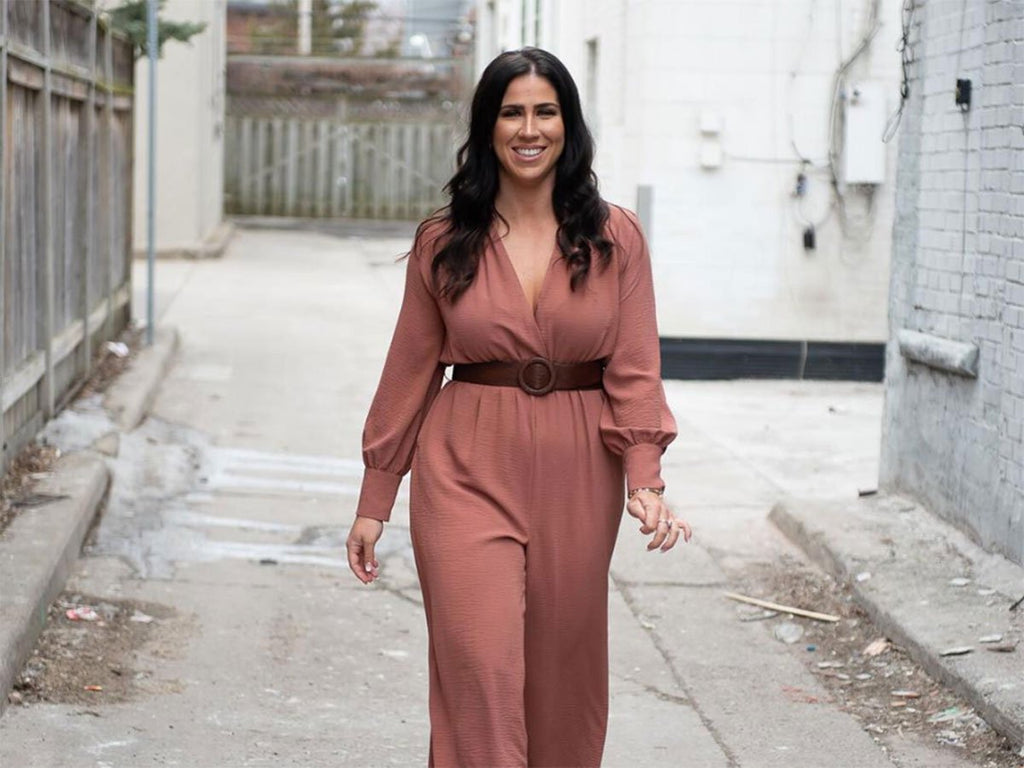Julie-Anne Nayler, Owner of Her Inner Heart, Registered Psychotherapist and Personal Trainer in rust coloured jumpsuit.