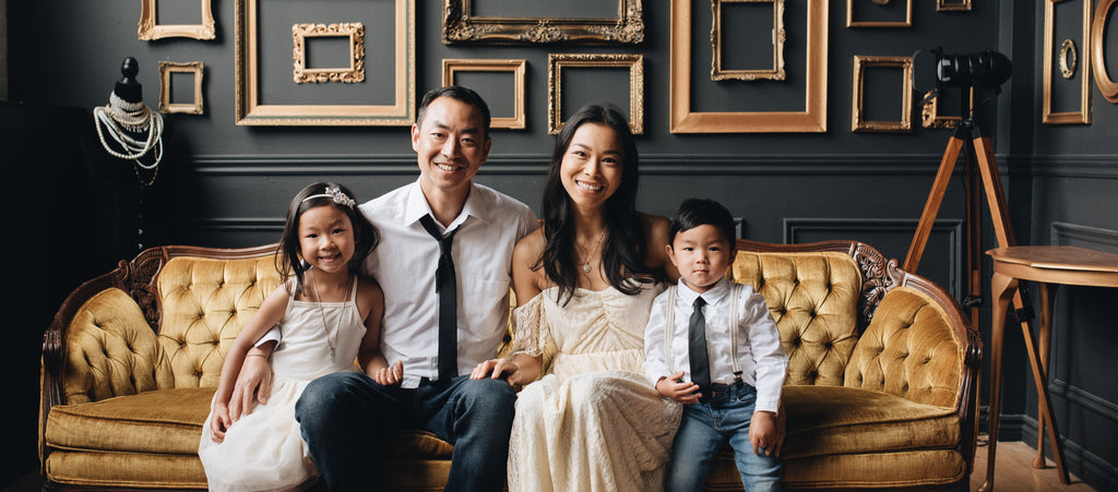 Joanna Duong Chang, Henkaa's late founder with her husband Stan and their two children sitting on a couch for family portraits on International Women's Day.