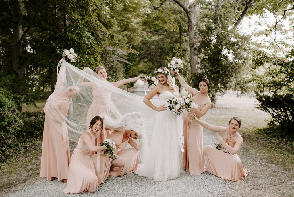 Megan and her bridesmaids strike a fun pose in their Henkaa Nude Champagne Sakura Maxi convertible dresses.