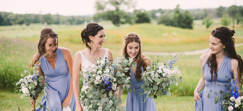 Rachel and her bridesmaids frolic on the golf course bouquets in hand. bridesmaids are wearing Henkaa Dusty Blue Sakura Maxi Dresses.