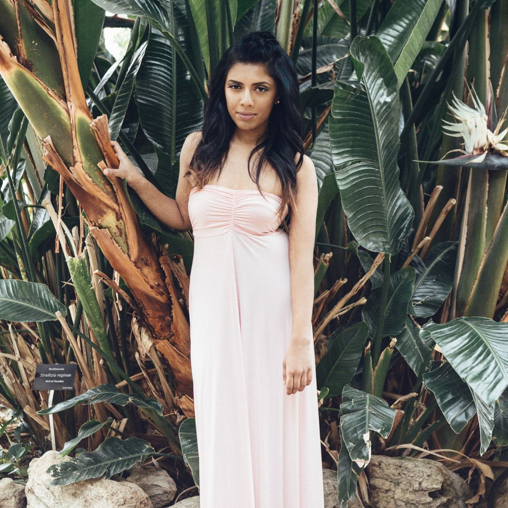 Model wearing pink Henkaa Viola strapless Dress in garden