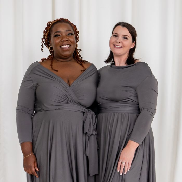 Two models wearing Henkaa Iris wrap dresses in Charcoal Grey
