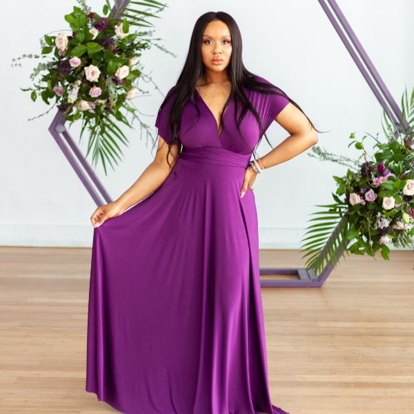 Model wearing purple Henkaa Sakura Maxi dress in front of flower arch